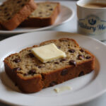 Delicious Pillsbury banana bread slice with chocolate chips and walnuts, perfect for breakfast or snack.
