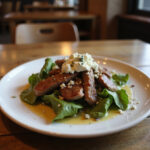 Delicious and refreshing cold steak salad served on a plate.