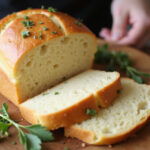 Freshly baked homemade cabbage bread loaf, sliced and ready to serve.