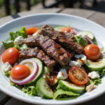 Delicious steak salad with fresh vegetables, blue cheese, and balsamic vinaigrette.