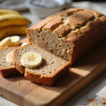 Delicious protein banana bread slices with banana garnish, ideal for a healthy snack.