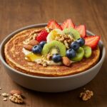 Delicious Baked Protein Pancake Bowls served with fresh fruits and maple syrup, ideal for a nutritious breakfast.