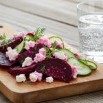 A stunning display of Beet Salad with Feta, Cucumbers, and Dill on a rustic table, emphasizing the freshness and vibrancy of the ingredients.