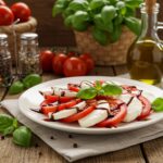 Finished Caprese salad with balsamic glaze served beautifully on a table, highlighting its fresh ingredients.