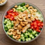 Overhead view of the delicious Chicken Cashew Crunch Salad featuring vibrant layers of chicken, vegetables, and cashews in a stylish bowl.