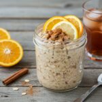 A stunning display of citrus-spiced overnight oats in a jar topped with fresh fruits, a perfect healthy breakfast idea.