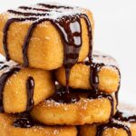 Delicious crispy deep fried marshmallows served as a dessert, highlighting their sweet and indulgent appearance.