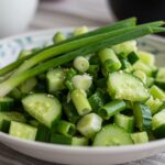 Finished Cucumber & Green Onion Salad, beautifully presented with vibrant colors, perfect for a refreshing meal.