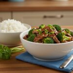 Final presentation of Easy Beef and Broccoli dish with sesame seeds and green onions, representing a delightful and wholesome meal.