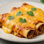 plated easy cheesy ground beef enchiladas garnished with cilantro, showcasing a deliciously cheesy and flavorful Mexican dish