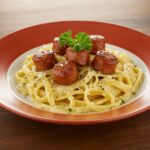 The final dish of Garlic Butter Sausage Bites with Creamy Parmesan Pasta, a deliciously inviting meal ready to be served.