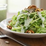 Final display of Green Goddess Cabbage Salad on a wooden table, showcasing freshness and vibrant flavors.