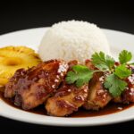 Delicious Hawaiian Shoyu Chicken served with rice and grilled pineapple, presenting an authentic Hawaiian meal.