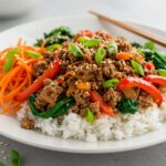 Gourmet presentation of a Korean Ground Beef Bowl displaying ground beef, steamed rice, and vibrant vegetables, perfect for a delicious meal.