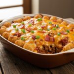 Final presentation of Loaded BBQ Bacon Tater Tot Casserole with melted cheese and garnished, ready to serve.