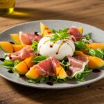 An exquisite melon-burrata-prosciutto salad ready to be served, showcasing the perfect combination of colors and textures.