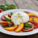 Beautifully arranged Peach Tomato Burrata Salad served in an inviting kitchen setting, highlighting its fresh ingredients and vibrant colors.