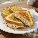 Final presentation of Shrimp-Stuffed Grilled Cheese with Garlic Bread, beautifully garnished, showcasing delicious flavors and textures.