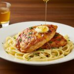 Final presentation of spicy Cajun honey butter chicken and pasta, showcasing a deliciously garnished dish.