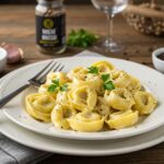 Completed Tortellini Carbonara, beautifully presented with garnishes, showcasing a delicious Italian meal in a rustic dining environment.
