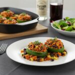 Final presentation of Zucchini-Black Bean Stuffed Peppers, a delicious and healthy meal with vibrant colors and garnished with fresh herbs.