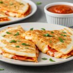 Deliciously sliced 5-Minute Pepperoni Pizza Quesadilla served with marinara sauce, crispy and cheesy comfort food.