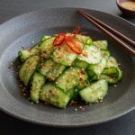 Asiatischer Gurkensalat mit Chili & Sesam served beautifully in a dish, showcasing the freshness and vibrant colors.