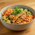 Delicious Bang Bang Chicken Bowl, colorful and appetizing with chicken, vegetables, and creamy sauce.