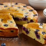Delicious Blueberry Buttermilk Pancake Casserole served on a table, showcasing its fluffy layers and blueberry filling, perfect for brunch.