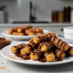 Delicious crispy air fryer churro bites served with chocolate sauce, a perfect dessert for celebrations or snacks.
