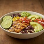 Beautifully arranged grilled chicken burrito bowl with rice, beans, and fresh toppings for a mouthwatering presentation.