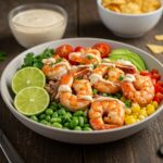 Final presentation of Grilled Shrimp Bowl with grilled shrimp, avocado, corn salsa, and creamy sauce.