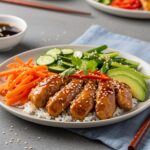 Irresistible Spicy Honey-Ginger Chicken Bowl beautifully plated with vibrant ingredients and creamy sauce, perfect for a tasty meal.