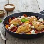 Final presentation of Mediterranean chicken skillet dish, garnished with herbs and feta, ready to serve.