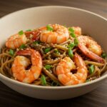 Delicious shrimp stir fry with noodles, garnished and presented in an elegant bowl, showcasing a vibrant and appetizing meal.