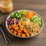 Final presentation of Thai Peanut Sweet Potato Buddha Bowl with roasted sweet potatoes and fresh vegetables, showcasing vibrant colors and textures.