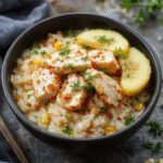 A vibrant street corn chicken rice bowl featuring grilled chicken slices, creamy roasted corn topped with cotija cheese, fresh cilantro, lime wedges, all arranged in a rustic bowl with colorful ingredients creating an inviting presentation.
