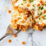 A golden-brown cheesy Dorito casserole sliced open to reveal a layers of melted cheese, seasoned ground beef, and crispy crunchy Doritos on top, garnished with fresh herbs, presented in a rustic baking dish with a cheesy, flaky crust and vibrant toppings.